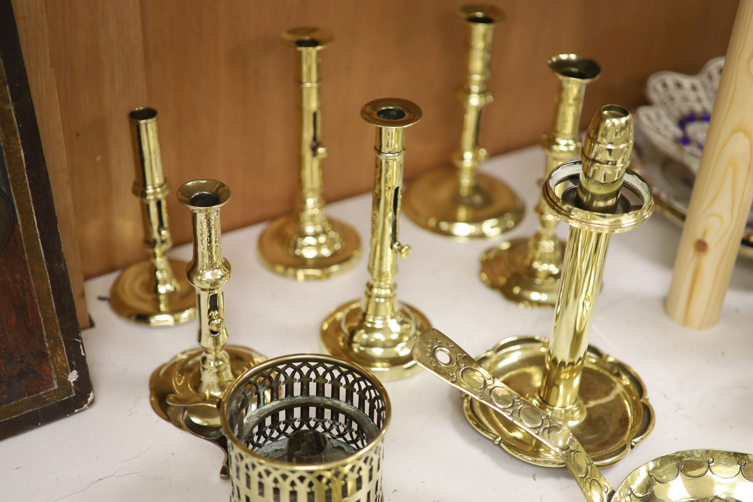 A quantity of 18th/19th century brass ejector candlesticks together with chambersticks, tallest 24cm